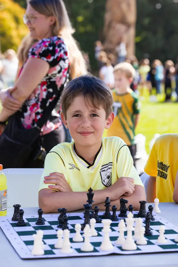 Child playing chess at the Multicultural Kids Festival in Portland