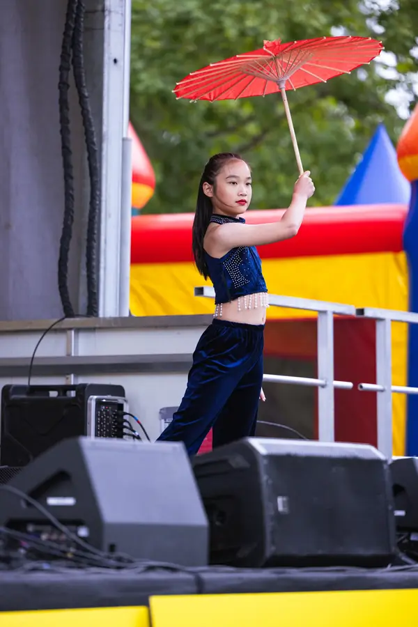 Chinese umbrella dance on stage at a Portland family festival