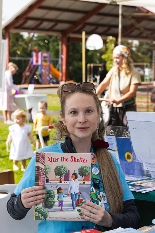 Library booth sharing books with families at the Portland festival