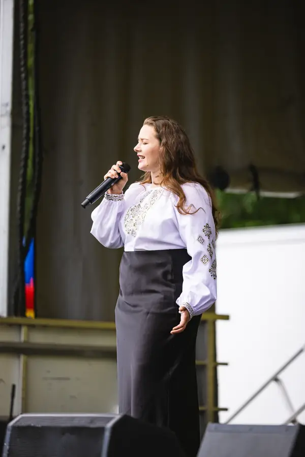 Singer in traditional clothing on stage at the multicultural festival