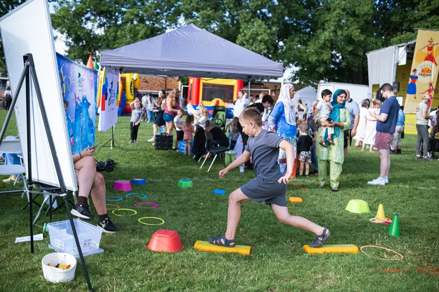 Kids activity zone with vendors and families at Ventura Park
